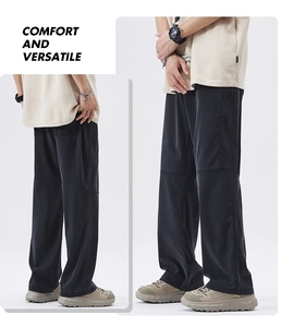 Detail view of black wide-leg trousers featuring seam stitching and premium drape fabric
