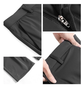 Detailed views of dark grey stretch trousers featuring elastic fabric and premium metal zipper