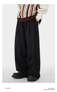 Detailed look at minimalist black wide-leg trousers paired with platform leather shoes