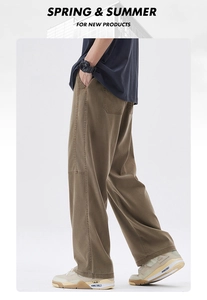 Detail shot of brown wide-leg cargo pants showing side pocket stitching and fabric texture