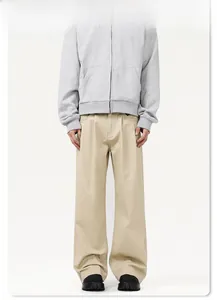 Detail of loose-fit straight wide-leg trousers in beige cotton with minimalist silhouette