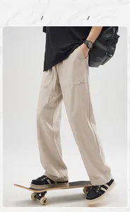 Detail of apricot linen drawstring trousers with ORIGINAL DESIGN label and texture