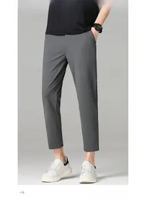 Close-up of men's slim fit grey ankle-length trousers with stylish casual outfit details