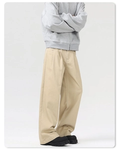 Detail view of khaki wide-leg pants showing premium cotton canvas fabric and side drape