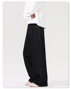 Side view of heavy indigo denim wide-leg jeans with a high-waisted baggy fit for men