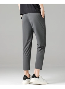 Rear view detail of dark gray slim fit cropped trousers showing high-quality fabric texture