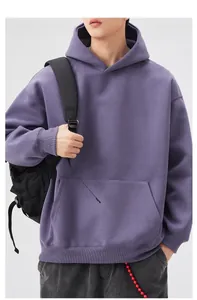 Detail view of purple oversized hoodie featuring kangaroo pocket and ribbed cuffs