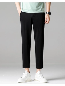 Detailed view of men's slim fit cropped ice silk trousers with smooth black fabric texture