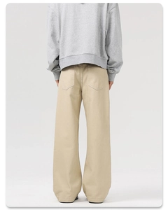 Detail view of khaki wide-leg trousers showing straight-cut fit and back pocket design