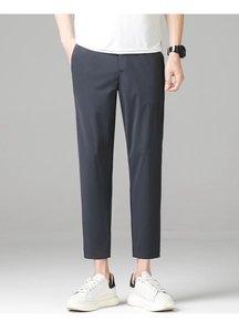 Detail view of men's slim fit cropped dress pants in dark grey for business attire