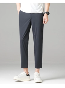 Slim fit charcoal grey business casual trousers paired with white sneakers and t-shirt
