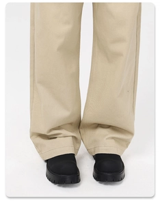 Close-up detail of beige wide-leg straight trousers with premium cotton twill texture