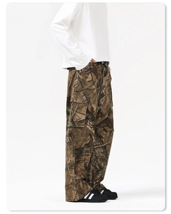 Detailed side view of camouflage cargo pants with utility pockets and a black waist belt