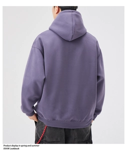 Detail view of the back of a loose purple hoodie with ribbed cuffs and hem