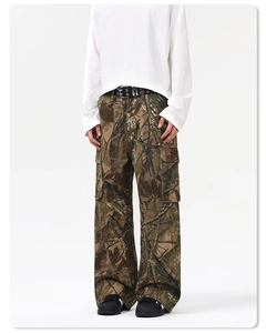 Detail of cargo pants showing branch camouflage print and large side flap pockets