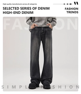 Detailed view of dark grey washed denim with vintage whiskering and straight leg cut