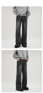 Detailed view of washed dark grey flare jeans featuring retro cat whisker texture