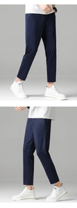 Detail of dark blue men's ice silk slim fit trousers with smooth draping fabric