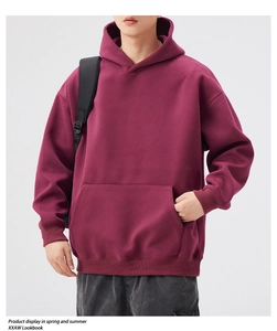 Detail view of burgundy heavy-weight oversized hoodie with kangaroo pocket and ribbed cuffs