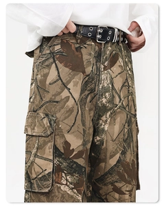 Detail of tree branch camouflage cargo pants featuring double-hole leather belt and side pockets