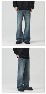 Detail view of light blue wide leg jeans with vintage wash and distressed cat whiskers effect