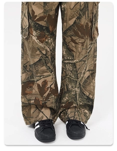 Close-up of camouflage cargo pants featuring large utility pockets and durable fabric texture