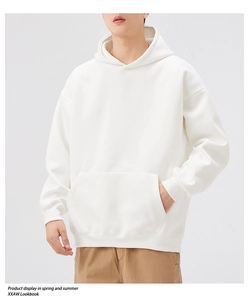 Detail of white heavyweight cotton hoodie showing kangaroo pocket and ribbed cuffs