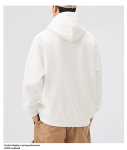 Back view of a minimalist white oversized hoodie with dropped shoulders and a soft cotton finish