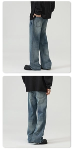Detail view of washed blue vintage denim jeans with baggy fit and distressed texture