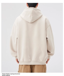 Rear view of an oversized beige hoodie with a thick texture and relaxed aesthetic fit