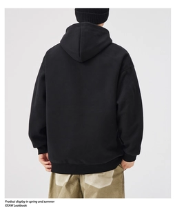 Rear view of a heavy black oversized hoodie showing dropped shoulder seams and premium fabric