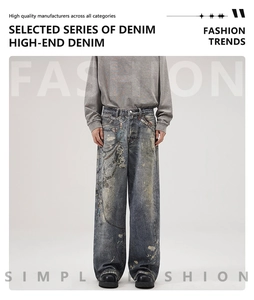 Detail of loose-fit vintage blue jeans featuring chain patterns and distressed streetwear style