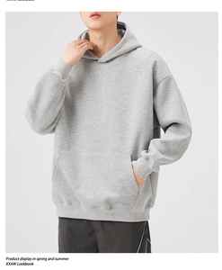 Detail of grey heavy hoodie showing kangaroo pocket and ribbed cuffs in a clean studio shot