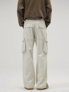 Back view of cream multi-pocket cargo pants with a loose straight leg and high street style