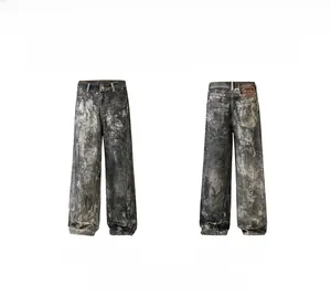 Detailed front and back view of gray washed denim pants with vintage leather patch