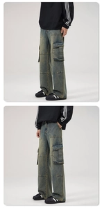 Detail of vintage washed multi-pocket cargo jeans with distressed texture and wide-leg fit