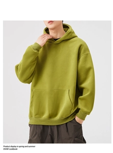 Detail shot of heavy grass green oversized hoodie with kangaroo pocket and ribbed cuffs