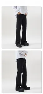 Slim fit men's flared black denim jeans shown on model with black work boots