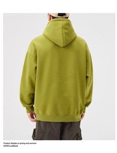 Rear view of grass green heavy cotton hoodie featuring drop shoulder and ribbed hem