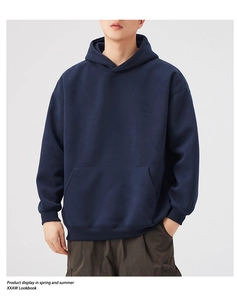 Detailed close-up of navy blue oversized heavy cotton hoodie with ribbed cuffs and hem