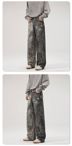 Detail view of baggy American style jeans with distressed digital print and grey wash finish