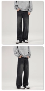 Detail view of charcoal grey washed flared denim jeans featuring faded vintage texture