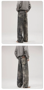 Close-up of heavy washed denim texture with vintage leather patch and rear pockets