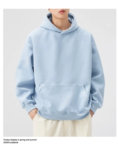 Detailed close-up of light blue oversized hoodie featuring premium heavy cotton texture