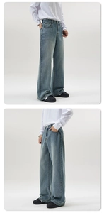 Detailed side view of vintage light blue wide-leg denim jeans with washed effect