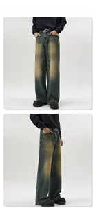 Detail of men's wide-leg denim jeans with vintage sandblasting and loose straight-leg cut