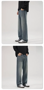 Detailed side view of vintage washed blue wide-leg jeans with natural denim texture