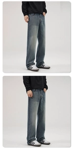 Detail view of men's vintage washed straight leg jeans showing fit and drape on model