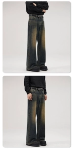 Close-up detail of vintage washed distressed wide-leg jeans with high-street vibe styling