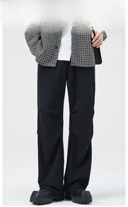 Minimalist black wide-leg trousers for men with a smooth drape and vintage styling